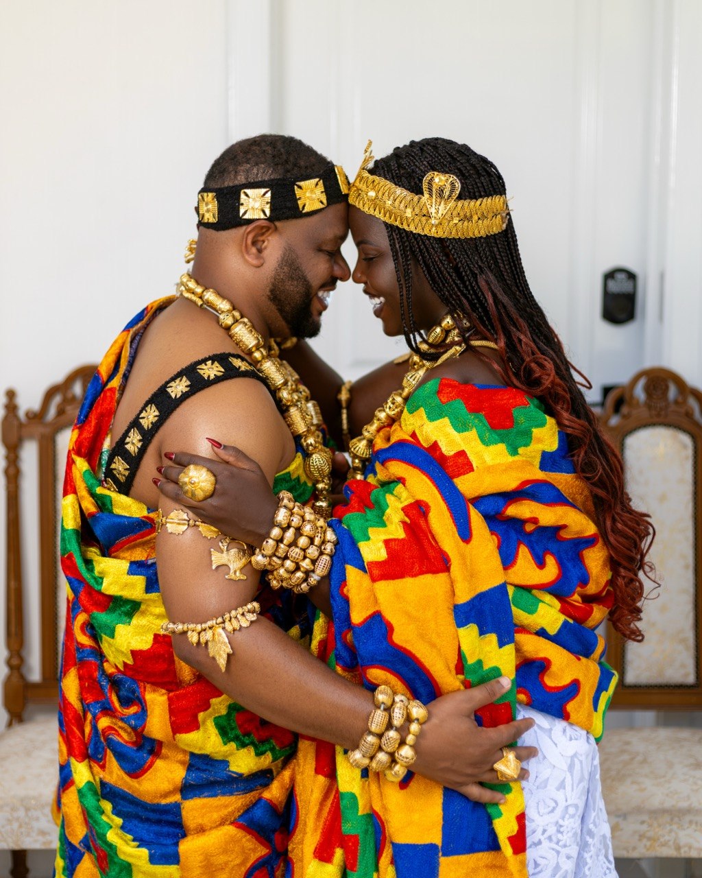 Claudine and Edward embracing with their foreheads gently touching